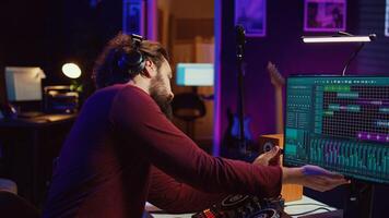 Audio engineer inserting an usb stick in the pc to record himself playing piano, mixing sounds and adjusting volume levels. Artist mastering audio recordings ready for release. Camera B. photo
