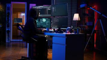 Hacker stealing credit card numbers while listening music through headphones. Evil developer programming in apartment, infiltrating banking systems, hearing songs, camera B photo