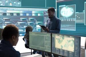 Governmental agency cyber defense team analyzing cyber attacks. IT security professionals working to prevent data breaches and protect against cybercrime, securing digital information. photo