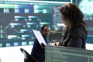 Cyber security team investigates governmental hacking malware attack on internet servers, high tech office. Cybercriminals hack computer systems, threatening account database protection. photo