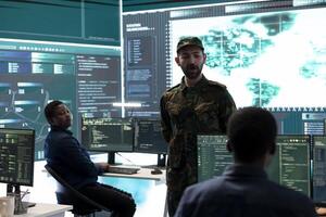 Military hackers working on cyber security in a high tech government center. Focusing on network protection, encryption and preventing cyber attacks to safeguard state secrets. photo
