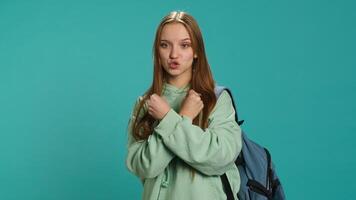 Assertive woman shows letter X with arms crossed, staying in warrior stance, showing fierceness. Firm young person using negative body language to signal rejection, studio background, camera A photo