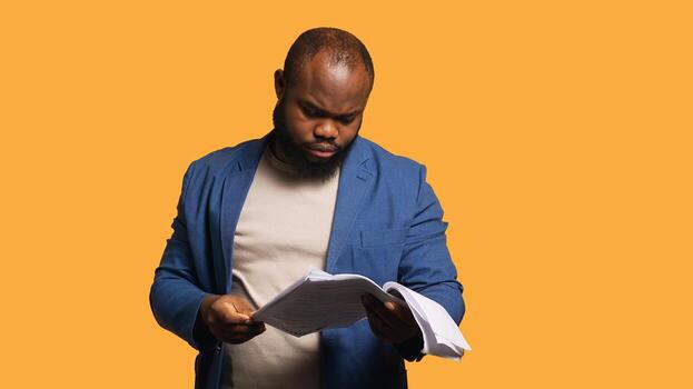 Man browsing though financial audit report files, throwing them in anger, feeling overworked, studio background. Stressed worker annoyed by too much paperwork, refusing to work anymore, camera A photo