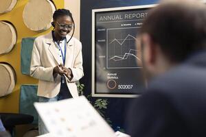 Enterprise workers reviewing organizational progress during a conference, conducting an analysis or benchmarking exercises. Business colleagues discuss activities and expansion plans. photo