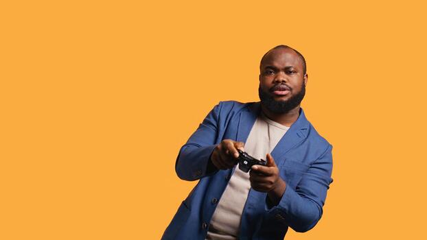 Gamer annoyed after losing online multiplayer videogame, being defeated by rivals. Man doing facepalm in frustration after seeing game over message, holding controller, studio background, camera B photo