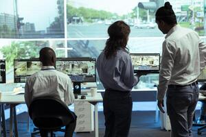 Agency employees operating on satellite map of the city to send gps coordinates for route to avoid traffic, helping couriers to delivery their orders in time. Operators monitoring their cars. photo
