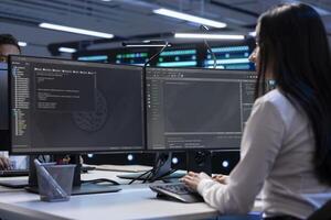 Team of engineer in data center running system diagnostic tests and error checking utilities to identify and resolve problems. Coworkers looking for network issues affecting server performance photo