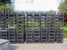 Stacked boxes on top of each other. Plastic seedling boxes. Empty containers photo