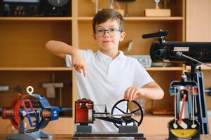 Physics lesson. A student at a desk with scientific instruments and a telescope photo