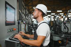 Technician operating machine in a factory photo