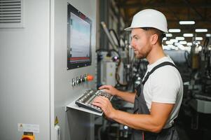 Technician operating machine in a factory photo