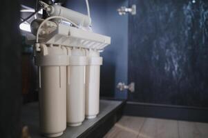 Reverse osmosis water purification system at home. Installed water purification filters. Clear water concept photo