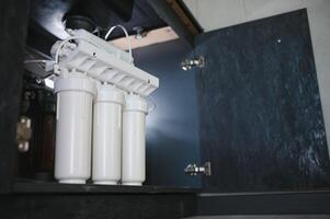 Reverse osmosis water purification system at home. Installed water purification filters. Clear water concept photo