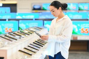 Buying new smart phone at tech store. Looking for a new peace of tech gadget photo