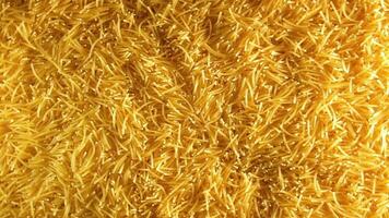 Background of Uncooked Noodles that Slowly Rotating Clockwise - Top View. Texture of Dry Vermicelli Turning Around. Raw Pasta with Low Key Light - Right Rotation video