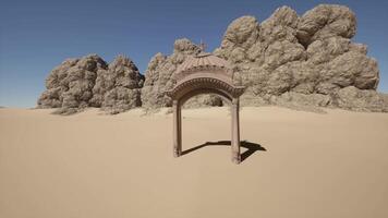 A small arch in the middle of a desert video