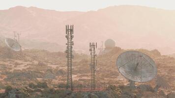 A group of satellite dishes on a desert landscape, capturing signals from space video