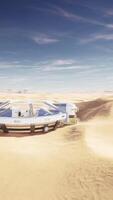 Enormous circular glass building standing alone in the desert video