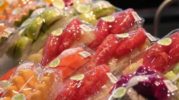 A close-up of exotic fruits displayed on supermarket shelves, showcasing vibrant colors and unique textures. This scene highlights the appeal of healthy, adventurous eating and culinary exploration video