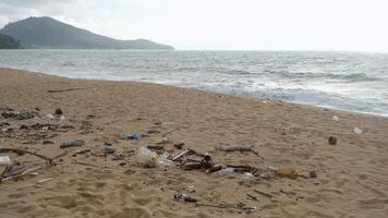 Garbage on the sandy beach of the ocean. The concept of environmental protection, ecology and cleanliness of coastlines video