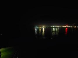 Aerial View of Illuminated Southampton Docks and Port City Centre During Dark Night. England United Kingdom. High Angle Drone's Camera Footage Captured from High Altitude on May 16th, 2024 photo