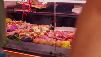 Medium shot meat department fullfilled with processed and raw meat products. video