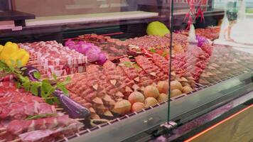 Display window butchers shop with meat arrangment either for grill. video