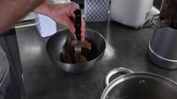 a man grinds cocoa beans food with a knife, cooking at home video