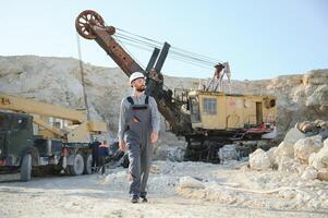 Portrait of a worker standing on the background of a stone quarry photo