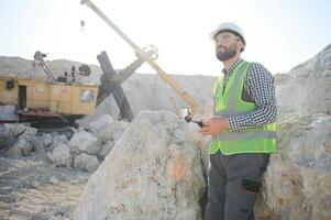 Worker and quarry in background photo