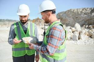 Two workers and quarry in background photo