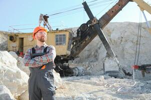 Worker and quarry in background photo