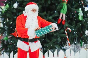 Portrait real authentic Santa Claus with Christmas gifts in hands in Shopping Mall photo