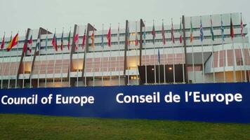 Council of Europe with lots of country flags in front of it. video