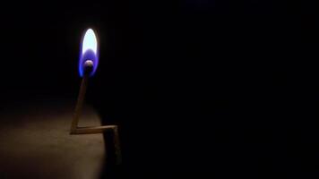 burning match on a light surface. The concept of a sad person. video