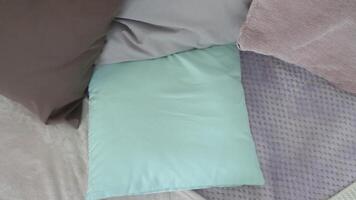 A little boy with short hair lies down on a pillow in bed and is getting ready to sleep having a good mood video