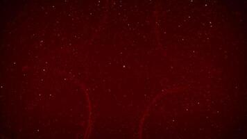 Christmas Glitter Swirl Snow Background 4K Loop features a dark red atmosphere with subtle swirls and particles animating on and off the screen in a loop. video