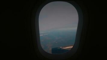 View of the land from a plane window in air on black backround. video