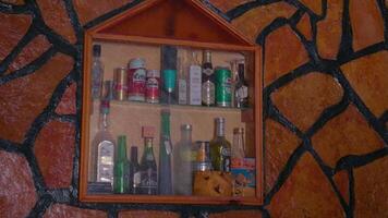 Bar counter with various alcoholic drinks on display. video
