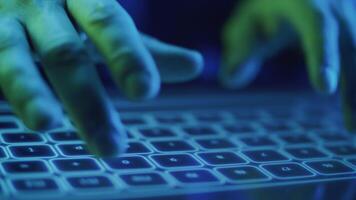 close-up of a hacker's hands typing text on a touch keyboard video