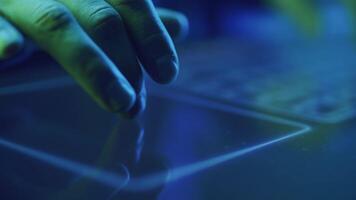 close-up of a hacker's hands runs his fingers over the touchpad video