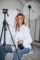 Woman photographer in a studio setting, using gear to capture creative images. photo