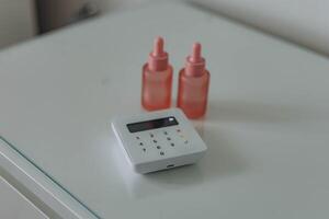 Pos terminal device for reading banking cards standing on a white table photo