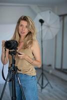 Woman photographer in a studio setting, using gear to capture creative images. photo