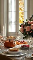 Autumn table setting with pie, pumpkins, and floral centerpiece in a cozy dining room photo