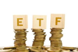Pile of golden money coin on white background and text on wooden block. Business, profit and financial concept. photo