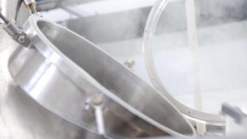 Adding of dried, granulated hops to the stainless steel tank for brewing the beer in a brewery, beer brewing concept video