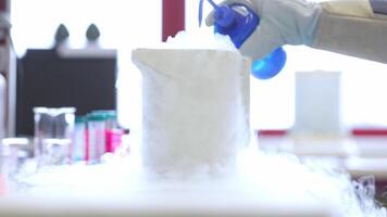 Laboratory technician doing lab research with a liquid nitrogen, lab experiment, chemistry concept video