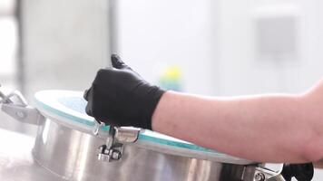 Adding of dried, granulated hops to the stainless steel tank for brewing the beer in the brewery, beer brewing concept video