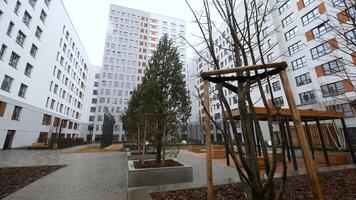 A closed courtyard with tall houses. Stock footage. Large high-rise houses around enclosed courtyards with playgrounds. video